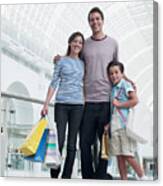 Smiling Family Shopping Together In Mall Canvas Print