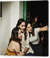 Smiling Female Friends Taking Selfie With Smart Phone While Hanging Out In Night Club Canvas Print