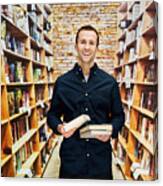 Smiling Male Bookseller In Library Canvas Print