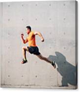 Sporty Asian Mid Man Running And Jumping Against Shutter. Health And Fitness Concept. Canvas Print