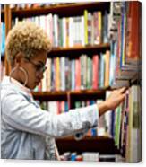 Student Choosing A Book On Library Canvas Print