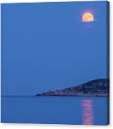 Supermoon Rising Behind Clouds Above The Sea Canvas Print
