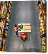 Top View Of Warehouse Worker Using Laptop To Check Location Of Goods. Canvas Print