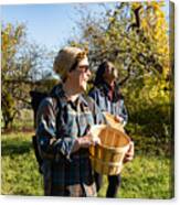 Two Adult Friends In 30s Walking Together With Apple Picking Baskets On A New York Farm In Autumn Canvas Print
