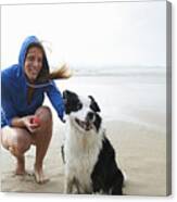 Woman And Dog On Beach. Canvas Print