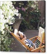 Woman Relaxing On Deck Chair In Backyard, Reading A Book Canvas Print