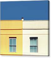 Yellow House, White House And Blue Sky. Canvas Print