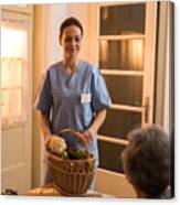 Young Home Caregiver Nurse Delivered Food To Senior Womens Home Canvas Print
