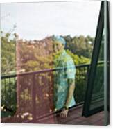 Young Man Smiling At Window Canvas Print