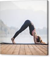 Young Woman In Dolphin Pose On Pier Overlooking Lake Bled Canvas Print