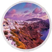 Santorini, Greece Beautiful city of Oia on a hill of white houses with blue  roof against dramatic pink sky, located in Greek Cyclades islands in Mediterranean  sea Beach Towel by Arpan Bhatia 