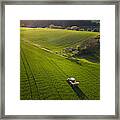 A Farmer Tills A Field With His Tractor Framed Print