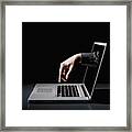 A Hand Reaching Through A Laptop To Type On The Keyboard Framed Print