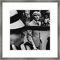 Woman In Telephone Booth Watched By Man Framed Print