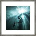 A Scuba Diver Ascends Into The Light Framed Print