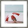 A Woman Buried In Sand At A Beach Framed Print