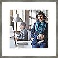 Businesswoman Holding Coffee Cup In Office Framed Print