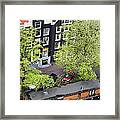 Canal Houses And Houseboat In Amsterdam Framed Print