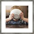 Caucasian Boy Eating From Bowl Framed Print