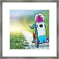 Child On Tricycle Carrying A Toy Space Rocket Framed Print