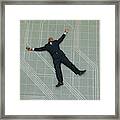 Conceptual Shot Of An African American Business Man As He Lays Flat On The Ground Holding His Phone Framed Print