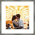Couple Kissing Near The Marry-go-round In The Park Framed Print