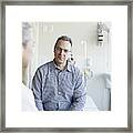 Doctor Talking To Patient In Hospital Room Framed Print