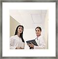 Doctors Standing In Hallway Framed Print