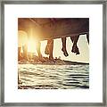 Family Sitting On Pier By The Sea Framed Print