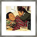 Father And Daughter On Sofa Framed Print