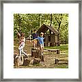 Friends Playing On Tree Stumps In Forest Framed Print