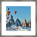 Hot Air Balloons Over Snow Covered Rock Framed Print