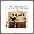 House And Garden Featuring A Woman Cooking Framed Print