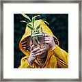 Little Boy With A Plant In A Jar Of Water Framed Print