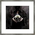 Man In The Hooded Cloak Holding Burning Human Skull In His Hand Framed Print
