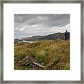 Man Standing Admiring The View Of A Loch Framed Print