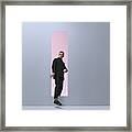 Man Walking Threw Rectangular Opening In Coloured Room Framed Print
