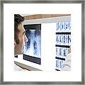 Medicine Doctor Examining Mri Scan On Light Box In Hospital Framed Print