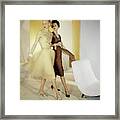 Models By A Chair Framed Print