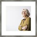 Portrait Of Confident Senior Woman Standing Arms Crossed Against White Background Framed Print