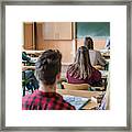 Rear View Of High School Students Attending A Class. Framed Print
