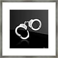 Silver Handcuffs On Black Background Framed Print