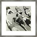 Simone Demaria And Models Sunbathing On A Beach Framed Print