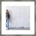 Smiling Young Asian Woman Leaning Back On Blank Wall Framed Print