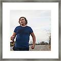 Teen Boy Jogging On Country Road Framed Print