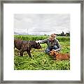 Teenage Girl Crouching And Petting Dogs Framed Print