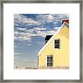 The Little Yellow House At The Seawall Framed Print