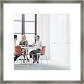 Three Women Sitting At Table In Modern Office Framed Print