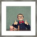 Young Boy Nerd Saves Money In His Piggy Bank Framed Print