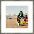 Young Boy Races Toy Car Wearing Framed Print